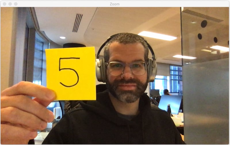 Holding up a sticky note while on a video call